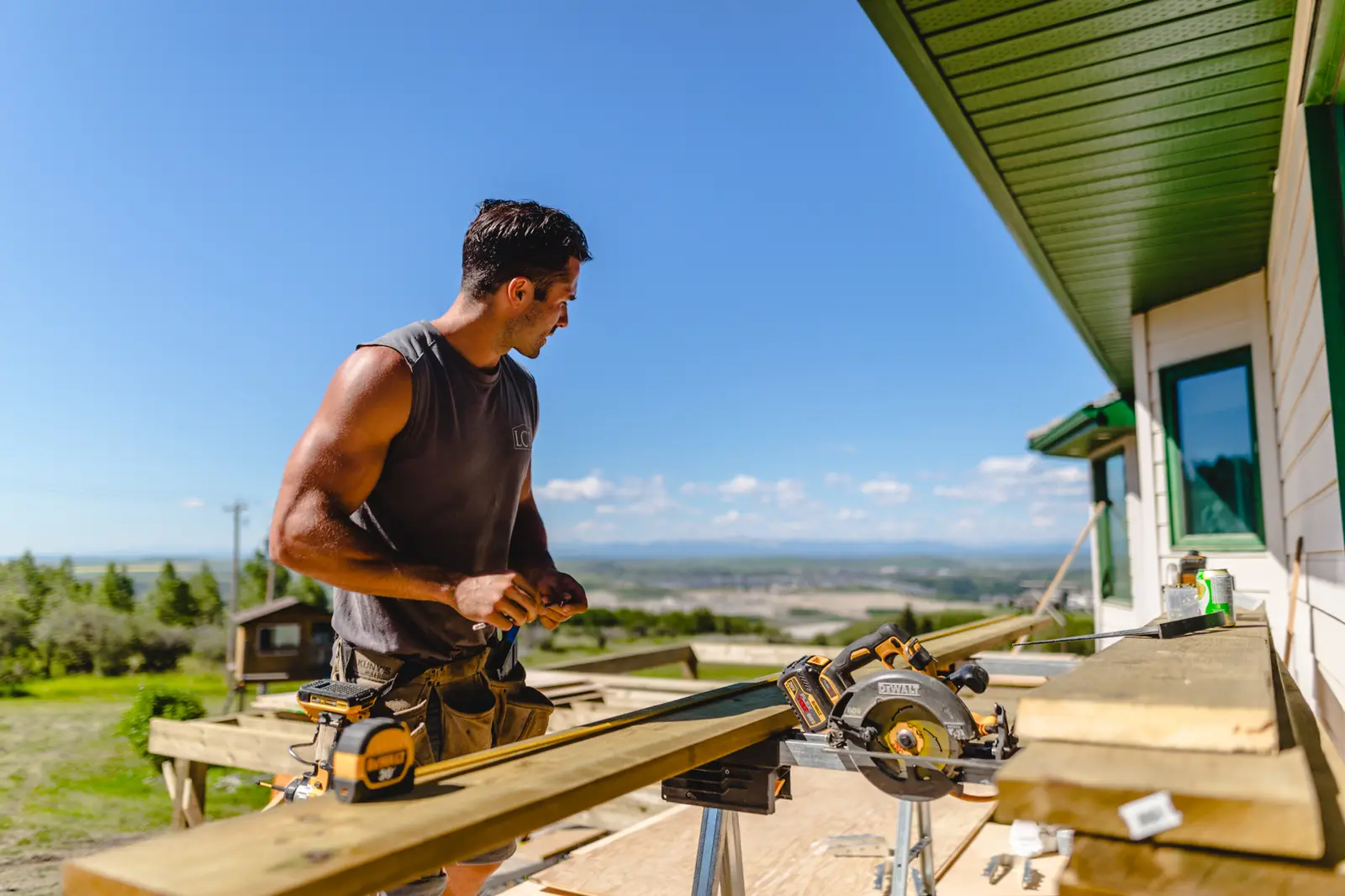 Lamacraft builder cutting deck boards on site