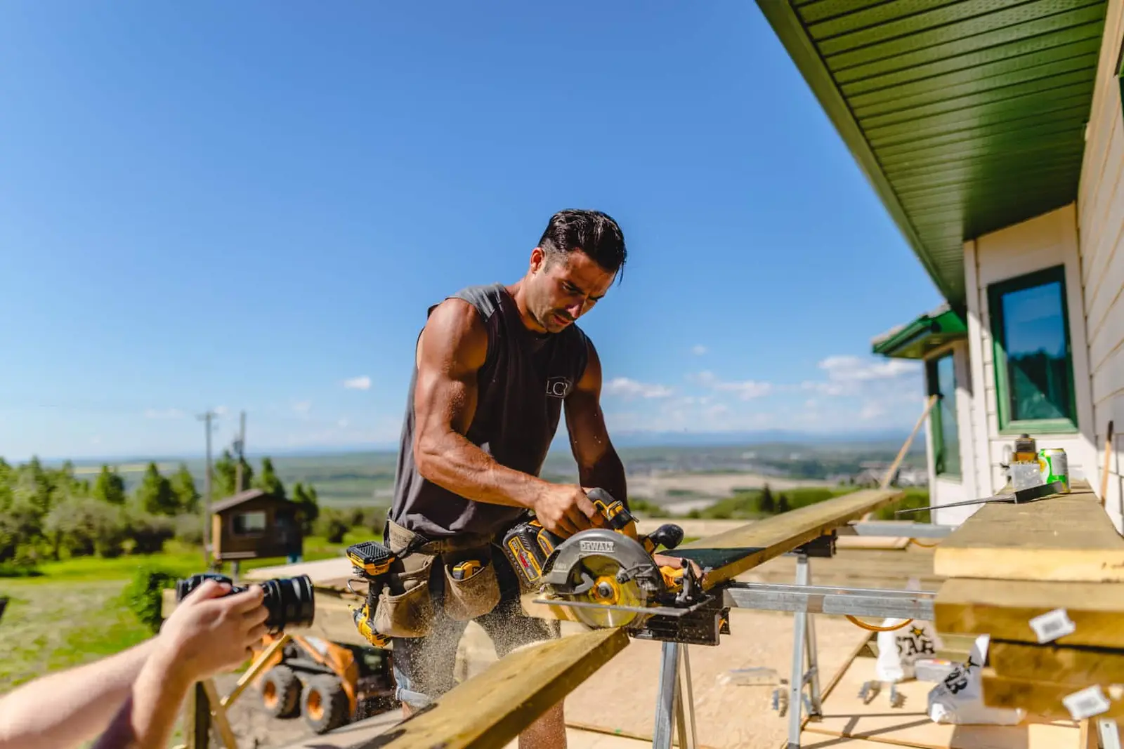 Brian cutting deck boards on a Lamacraft site above the foothills